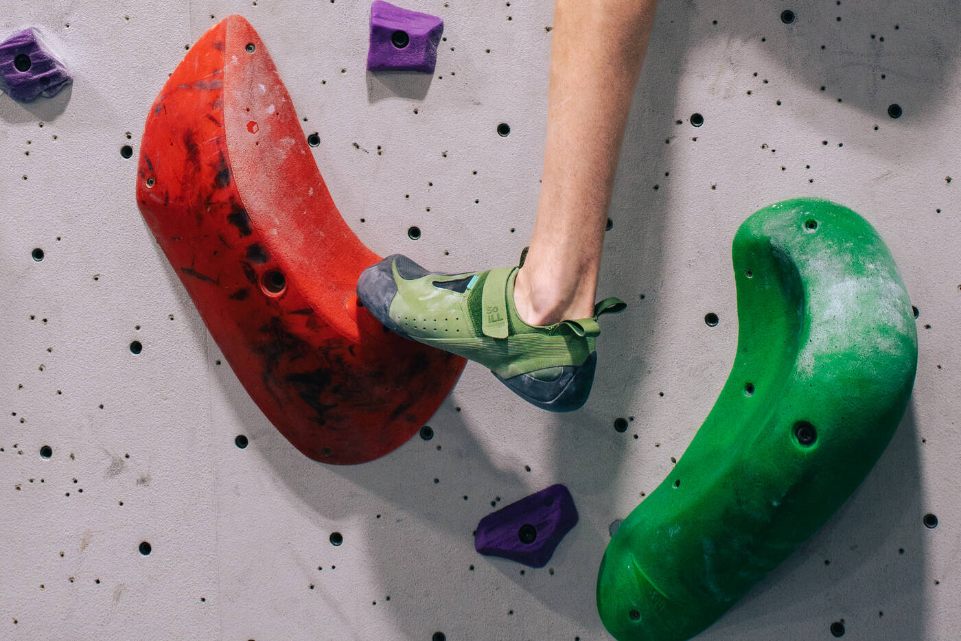 Climbing shoe on a red hold