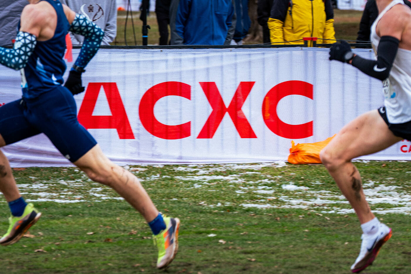 Runners passing the ACXC championship banner