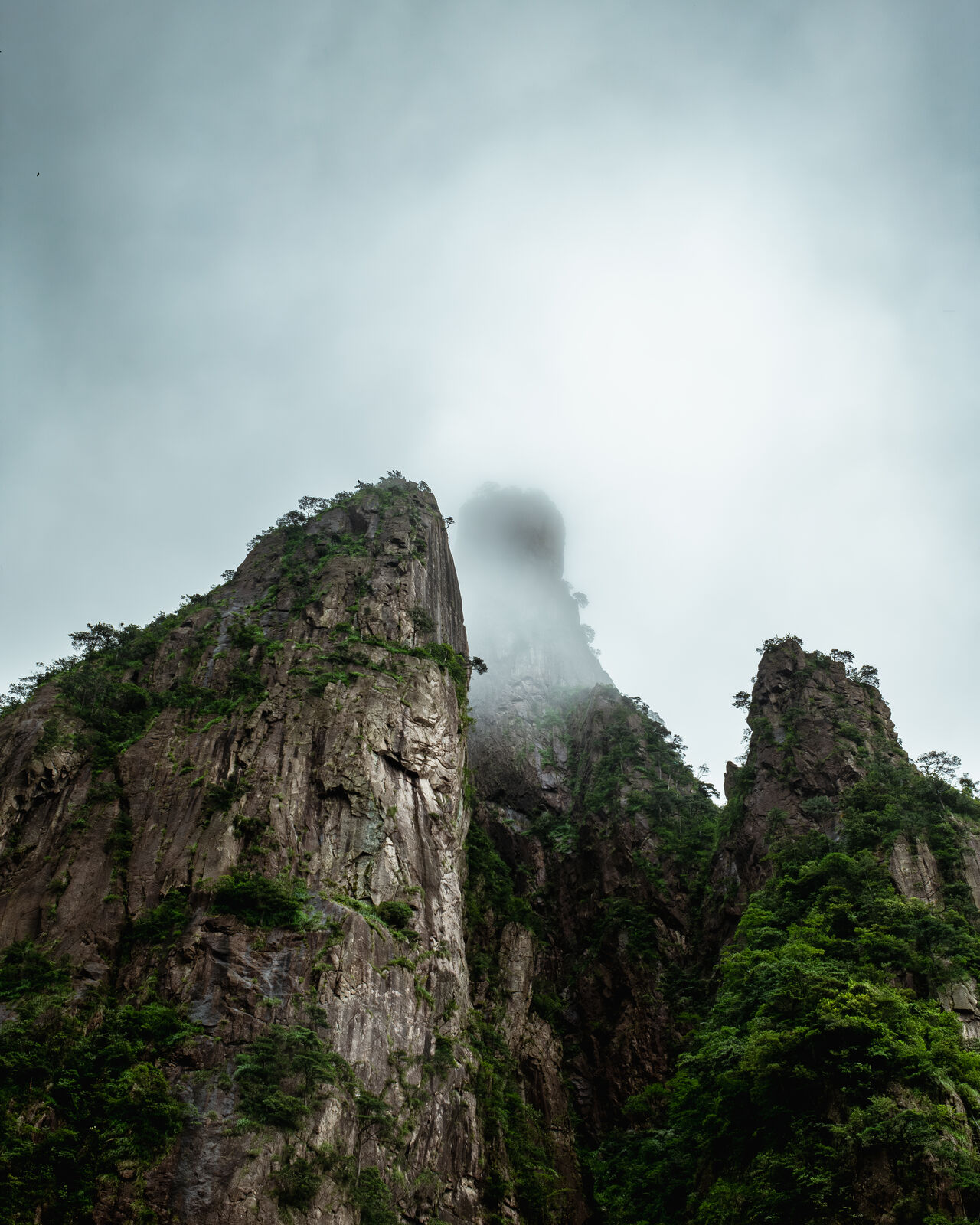 Granite peak dissolving into fog, Huangshan, China